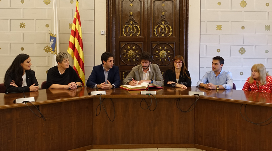Tercer per l'esquerra, l'alcalde Joan Barrera i, al seu costat, signant el Llibre d'Honor, Cerni Cairat (Aj. la Seu)