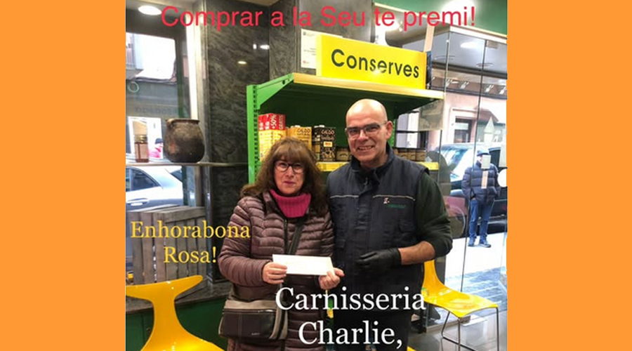 Rosa Ballesteros recull, a Carnisseria Charlie, el val de 100 euros que ha guanyat en el concurs 'Comprar a la Seu té premi' (RàdioSeu)
